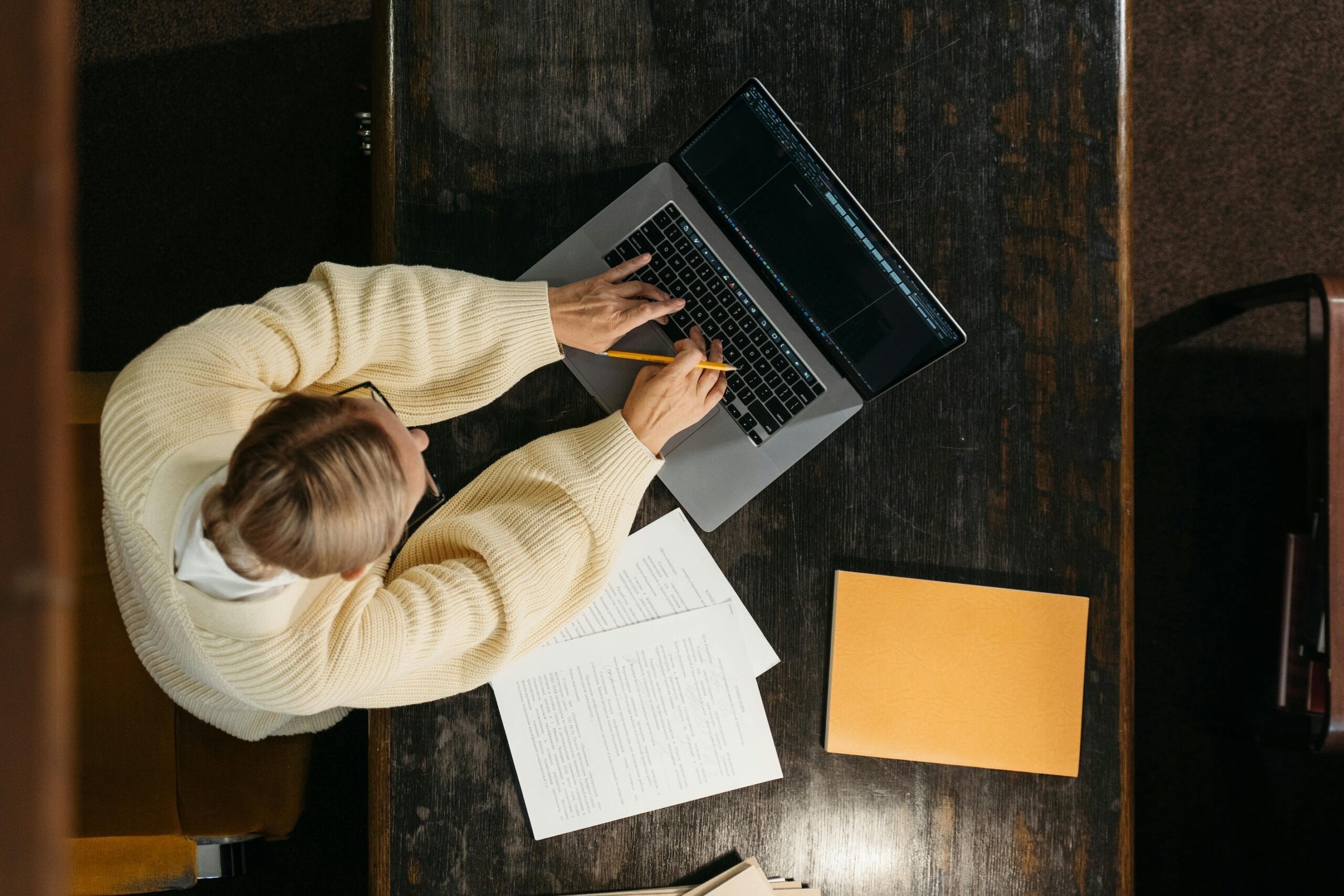 An overhead view of a man working at his computer