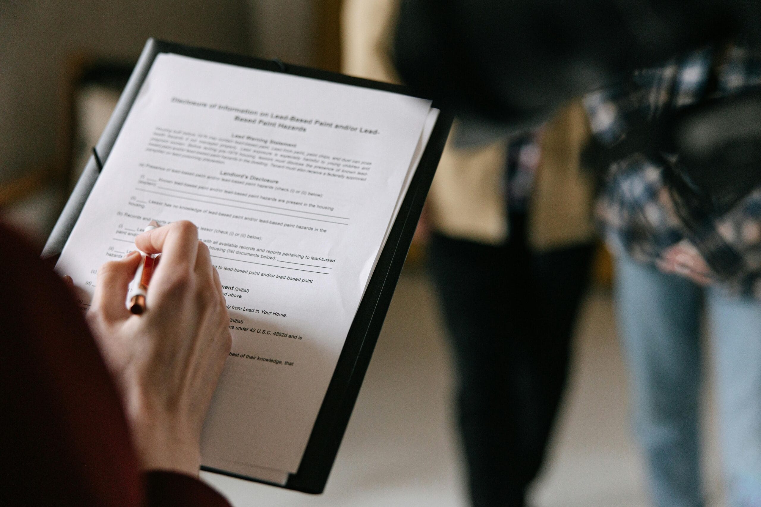 a woman with a clip board filling out a form