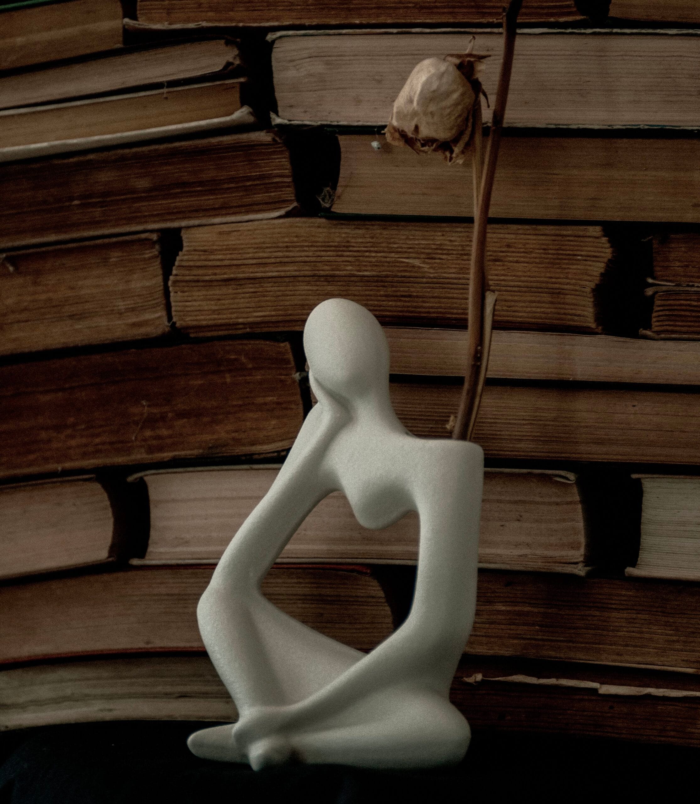 postmodern statue with books in library