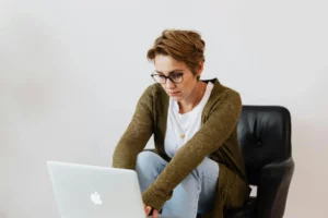 therapist at computer seriously contemplating