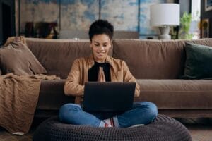 happy woman writing a soap therapy note at a computer