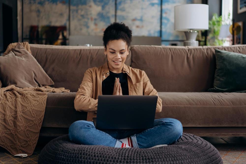 happy woman writing a soap therapy note at a computer